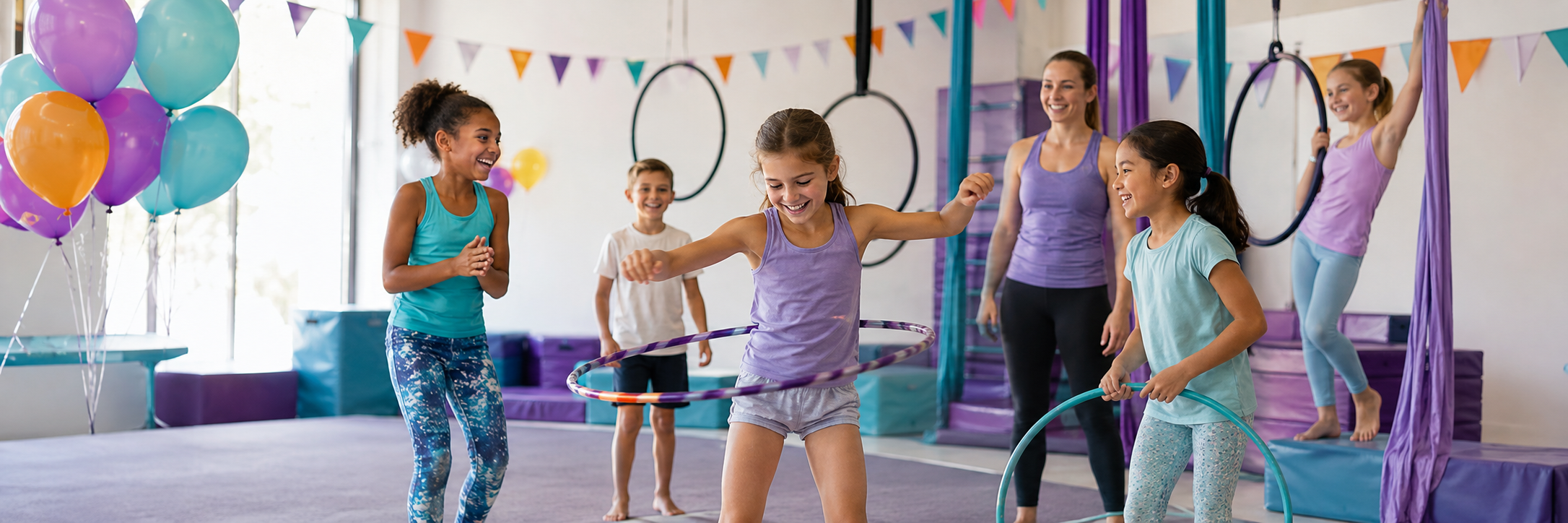 Children celebrating a circus-themed birthday with hoops and aerial silks in a bright gym